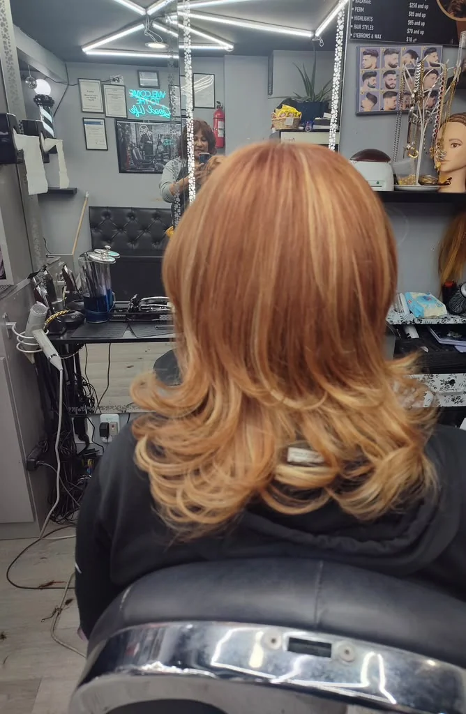 Copper colored hair with layered, curled ends
