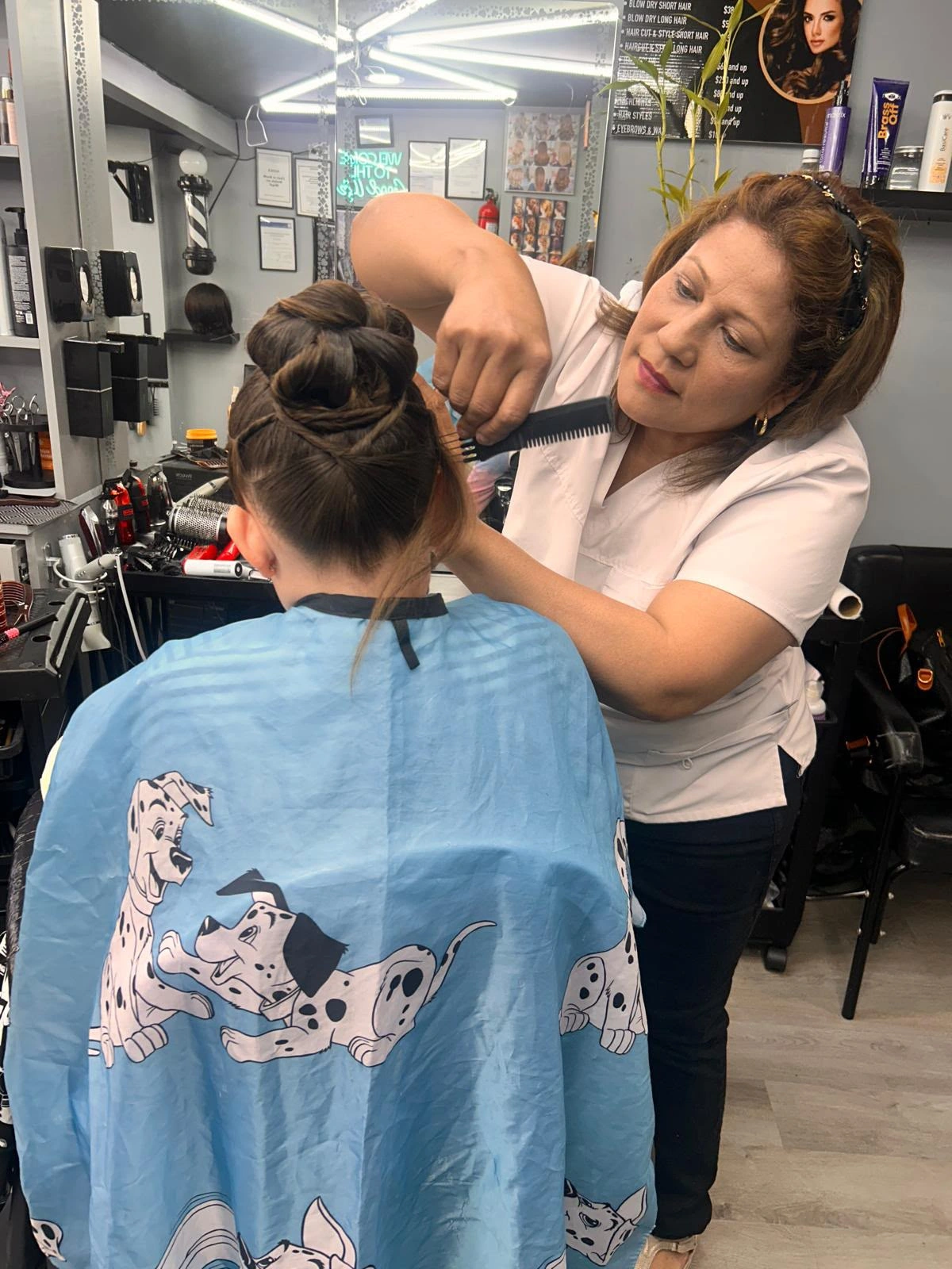 A New Style stylist shaping an elegant braided updo